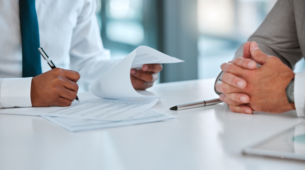 Signing documents on a clean table