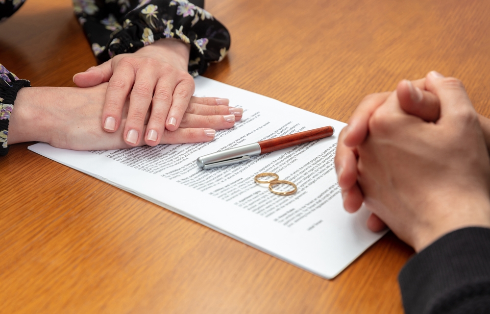 Photo of divorce papers with 2 wedding rings.